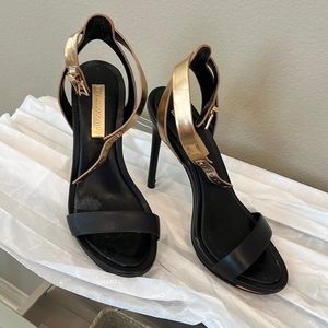 BCBG Maxazria 4.5” heels black leather with gold strap.